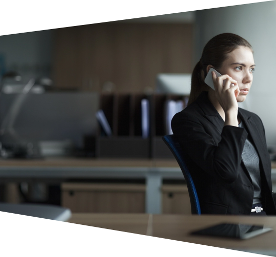 Young woman in business attire talking on the phone