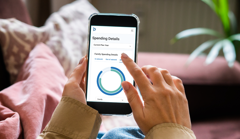 Hands holding a phone with the Blueprint Portal Spending Details