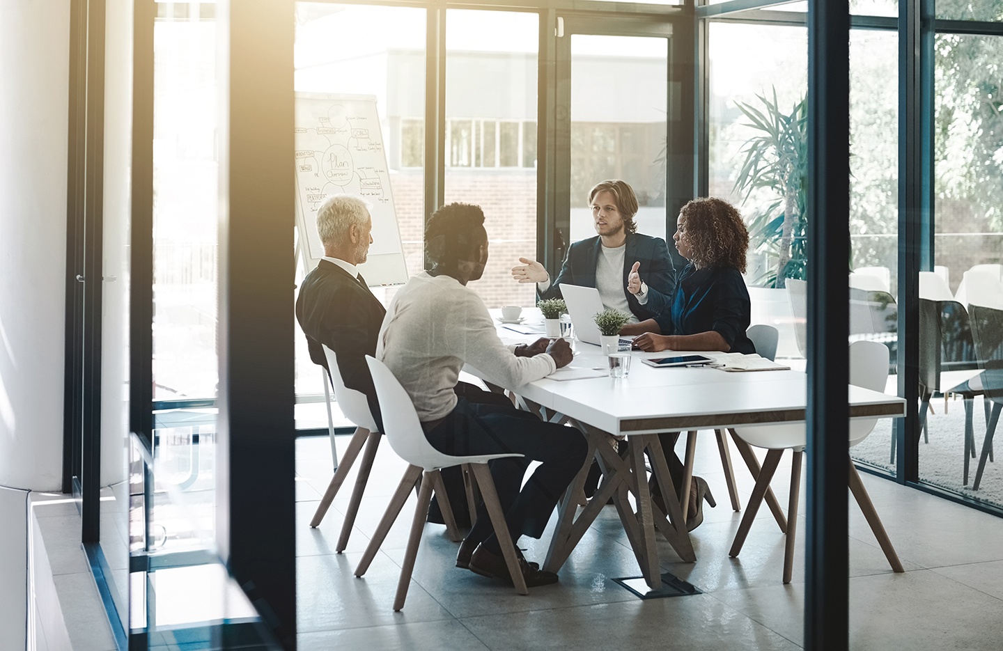 Group of people sitting in office space having a meeting