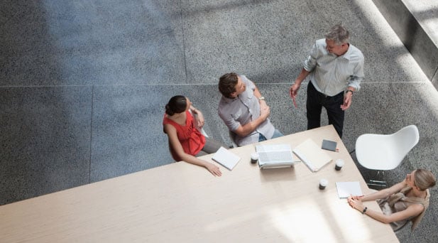 img-insights Employees sitting at conference table