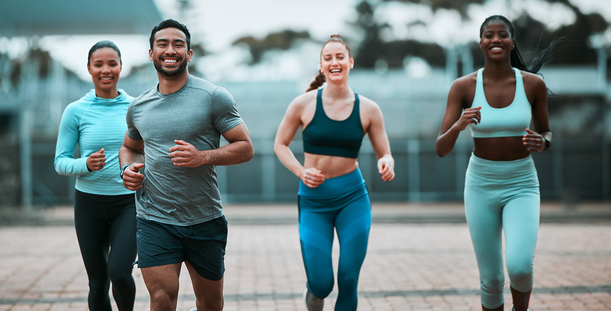 Group of four people running