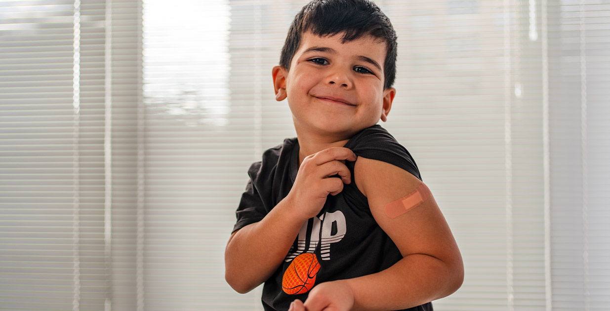 You child showing that he got his flu shot.
