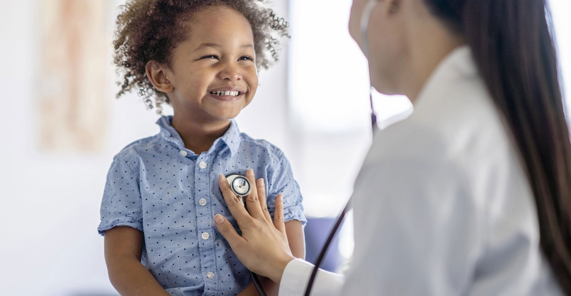 Doctor checking childs heart beat
