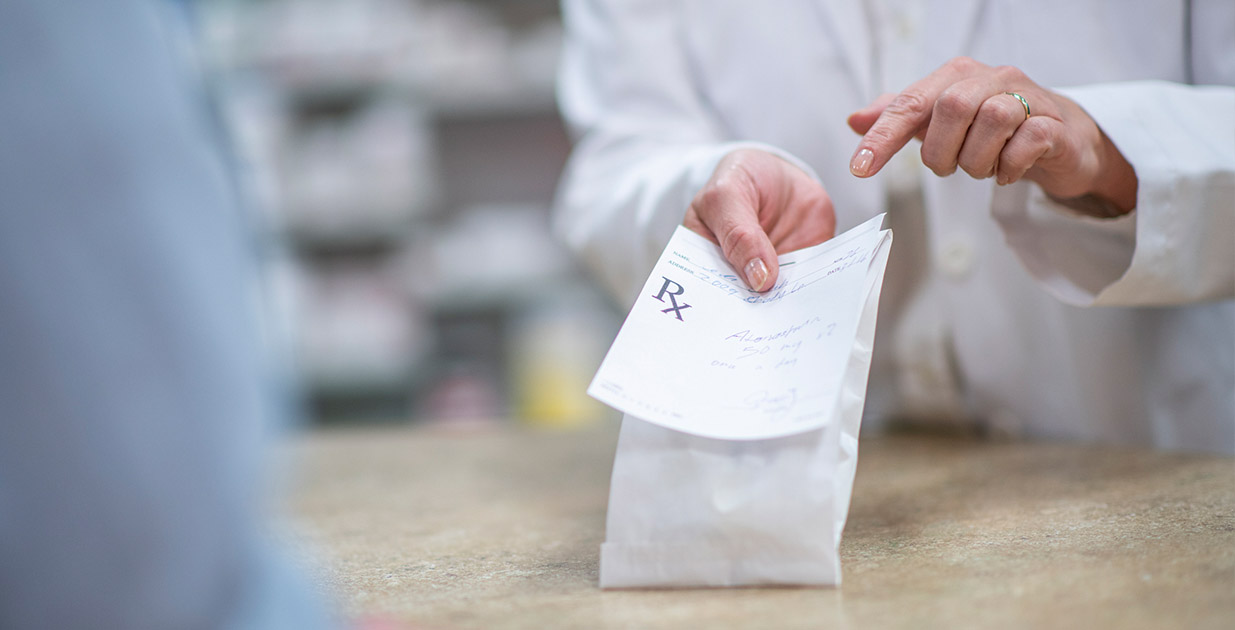 Pharmacist pointing to prescription