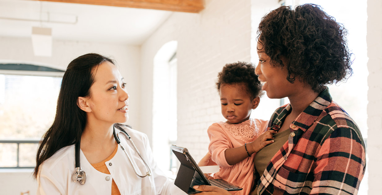 Mother and daughter speaking to a doctor