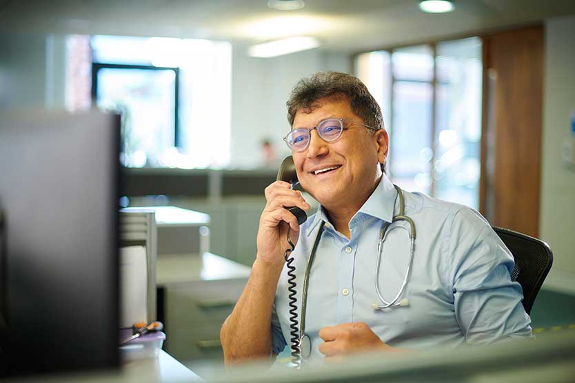 Man on phone with a stethoscope around neck