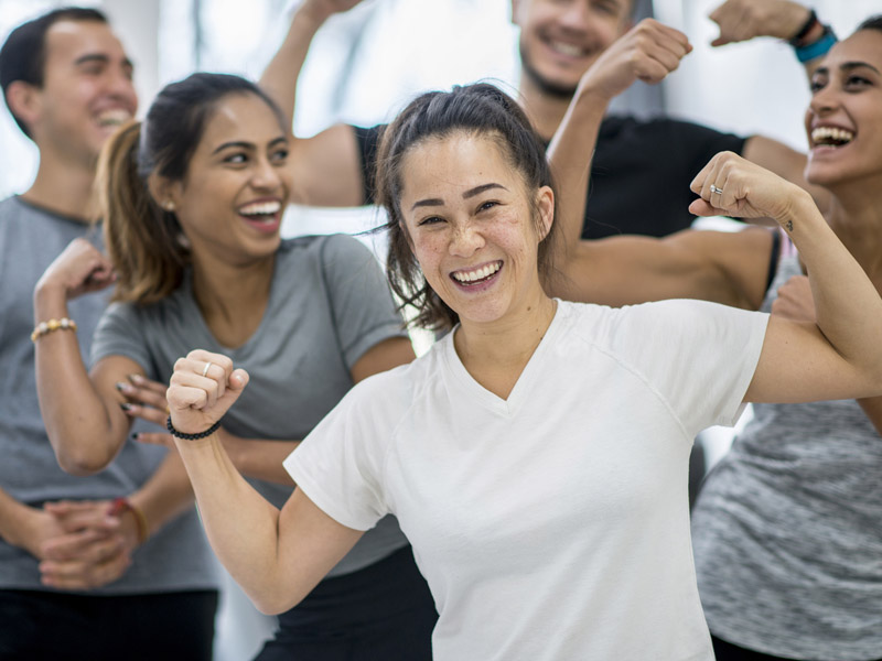 byfc-howdoesitwork Group of people flexing their biceps