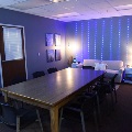 Dimly light calm room with a couch, table, and various items to help calm someone