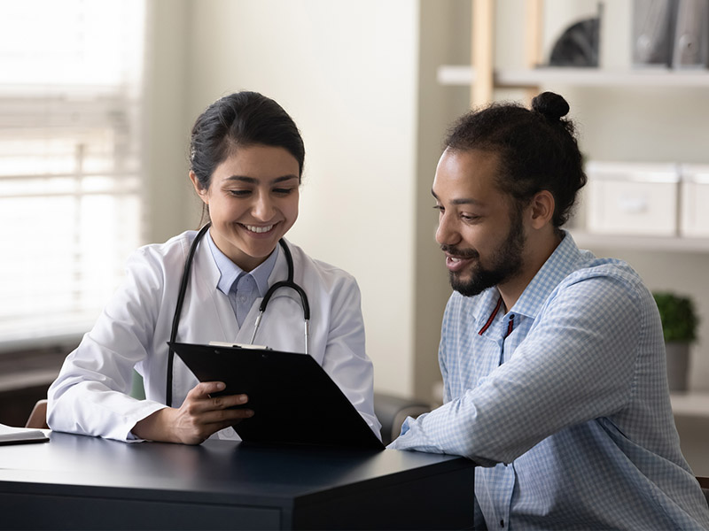 Patient and doctor looking over results on a clipboard