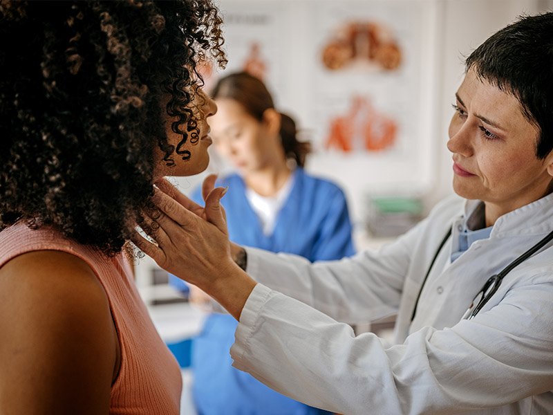 womens Women having her throat checked in a doctor's office