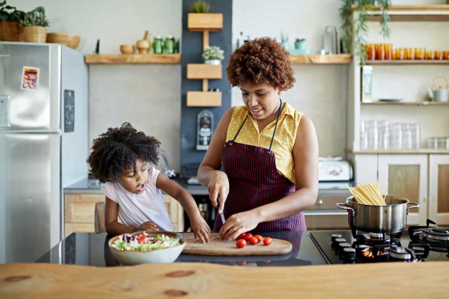 family-cooking A woman and while cooking a meal in a kitchen